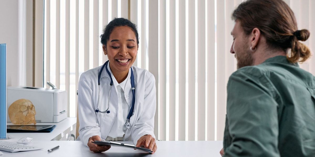 A provider and patient talking warmly at the end of a visit.